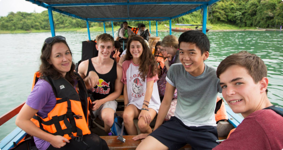 Group of participants posing for a photo on a boat